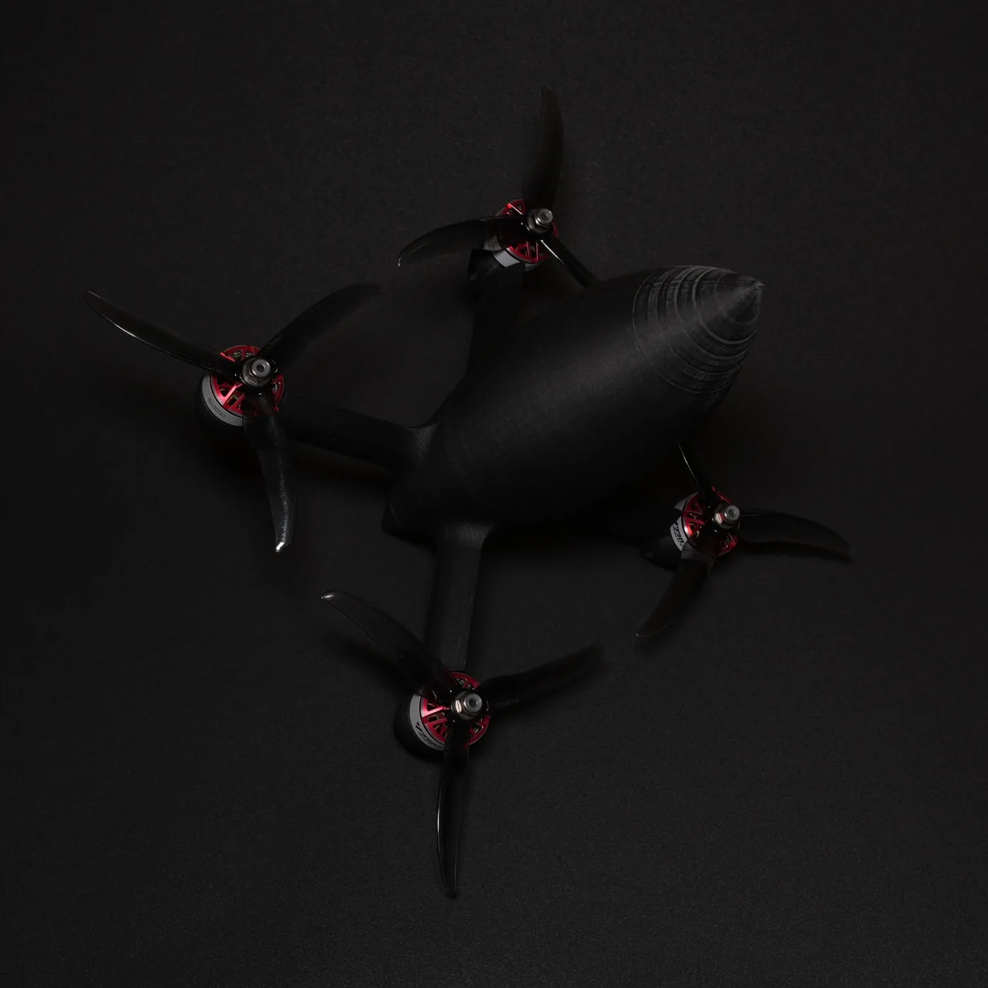 Three-quarter detail view of the first drone revision highlighting the printed body, arm geometry and propulsion layout